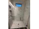 Modern bathroom featuring an all-glass enclosed shower with white tile and dark accents at 8289 Topsail Pl, Winter Garden, FL 34787