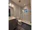 Bright, updated bathroom featuring a walk-in shower with marble-style tile at 8289 Topsail Pl, Winter Garden, FL 34787