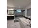 Luxurious bathroom with a sleek glass shower, soaking tub, stylish vanity, and elegant tile flooring at 8289 Topsail Pl, Winter Garden, FL 34787
