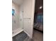 Stylish bathroom highlighting a tiled shower with glass door and a glimpse into bedroom at 8289 Topsail Pl, Winter Garden, FL 34787