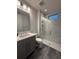 Sleek bathroom with a modern shower, gray vanity, and great lighting at 8289 Topsail Pl, Winter Garden, FL 34787
