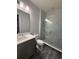 Modern bathroom with a marble-tiled shower, elegant vanity, and sleek fixtures at 8289 Topsail Pl, Winter Garden, FL 34787