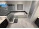 Bathroom featuring a sleek glass shower, soaking tub, vanity, and elegant marble tile flooring at 8289 Topsail Pl, Winter Garden, FL 34787