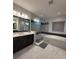 Luxurious bathroom with a sleek glass shower, soaking tub, stylish vanity, and elegant tile flooring at 8289 Topsail Pl, Winter Garden, FL 34787