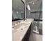 Bathroom featuring a dual sink vanity with countertop, modern fixtures, and large mirror at 8289 Topsail Pl, Winter Garden, FL 34787