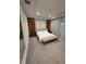 Spacious bedroom featuring light colored walls, a bed and bench with dark wood accents at 8289 Topsail Pl, Winter Garden, FL 34787
