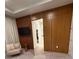 Modern bedroom featuring a tv, lounge chair and wood accent wall at 8289 Topsail Pl, Winter Garden, FL 34787