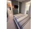 Contemporary bedroom with a flat-screen TV, closet and ensuite bathroom at 8289 Topsail Pl, Winter Garden, FL 34787
