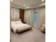 Well-lit bedroom with a comfortable bed, bench, and chair at 8289 Topsail Pl, Winter Garden, FL 34787