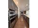 An elegant kitchen featuring stainless steel appliances and a seamless flow into the living room at 8289 Topsail Pl, Winter Garden, FL 34787