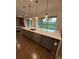 This kitchen features a large island with modern fixtures and an adjacent view of the landscaped lawn at 8289 Topsail Pl, Winter Garden, FL 34787
