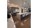 Open kitchen featuring an island with seating, stainless steel appliances, and sleek gray cabinetry at 8289 Topsail Pl, Winter Garden, FL 34787