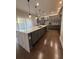 Bright kitchen with a center island, stainless steel appliances and bar stool seating at 8289 Topsail Pl, Winter Garden, FL 34787