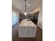 Kitchen with a large center island, pendant lighting, and stainless steel appliances, perfect for entertaining at 8289 Topsail Pl, Winter Garden, FL 34787
