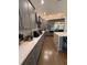 Stylish kitchen featuring quartz counters, stainless appliances, and gray cabinetry with ample counter space at 8289 Topsail Pl, Winter Garden, FL 34787