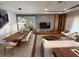 Modern living room featuring dining area, a media center, sleek hardwood floors and stylish decor at 8289 Topsail Pl, Winter Garden, FL 34787