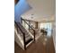 Modern living room with sleek hardwood floors, dining area, contemporary staircase and plenty of natural light at 8289 Topsail Pl, Winter Garden, FL 34787