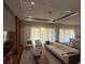 Bright open concept living room featuring large windows with sheer curtains and modern decor at 8289 Topsail Pl, Winter Garden, FL 34787