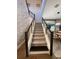Staircase with modern wood and metal railings with natural light and decorative wall finishes at 8289 Topsail Pl, Winter Garden, FL 34787
