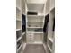 Bright walk-in closet featuring custom shelving, drawers, and ample space for clothing and accessories at 8289 Topsail Pl, Winter Garden, FL 34787
