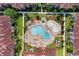 A sprawling community aerial view featuring pools, cabanas, sun loungers, and manicured landscaping in a tranquil setting at 841 Retreat Blvd # 101, Davenport, FL 33897