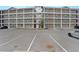 Apartment building with multiple stories, balconies, and a spacious parking area for residents and guests at 841 Retreat Blvd # 101, Davenport, FL 33897
