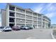 Multi-story apartment building showcasing a large exterior with multiple balconies and ample parking for residents at 841 Retreat Blvd # 101, Davenport, FL 33897