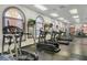 A state-of-the-art gym featuring treadmills, elliptical machines, and large arched windows for plenty of natural light at 841 Retreat Blvd # 101, Davenport, FL 33897