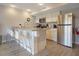 Bright kitchen featuring stainless steel appliances, granite countertops, and barstool seating at 841 Retreat Blvd # 101, Davenport, FL 33897