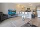 Open living space featuring a bar, kitchenette, wood-look floors, and comfortable seating at 841 Retreat Blvd # 101, Davenport, FL 33897