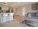 Open living space featuring wood flooring, a cozy couch, kitchen access, and plenty of seating at 841 Retreat Blvd # 101, Davenport, FL 33897