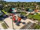 Aerial view of an outdoor bar and lounge area with seating and umbrellas, surrounded by tropical landscaping at 841 Retreat Blvd # 101, Davenport, FL 33897