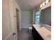 Bathroom with tub, natural light, and a double vanity that offers plenty of counter space at 9081 Oscraft Dr, Davenport, FL 33896