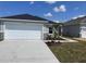 Charming single Gathering home featuring a two car garage, neutral color palette, and simple landscaping at 9081 Oscraft Dr, Davenport, FL 33896