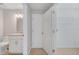 Bathroom features a granite vanity, toilet, and a closet with wire shelving at 943 Van Loon Ct, Kissimmee, FL 34758
