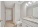Bright bathroom with white cabinets, granite counters, and glass shower enclosure at 943 Van Loon Ct, Kissimmee, FL 34758