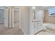 Bathroom with double sink vanity, granite countertop, and combo bath at 943 Van Loon Ct, Kissimmee, FL 34758