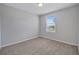 Bright bedroom featuring neutral walls, carpet, and a window with blinds at 943 Van Loon Ct, Kissimmee, FL 34758