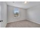 Neutral bedroom with standard window and simple trim and carpet at 943 Van Loon Ct, Kissimmee, FL 34758