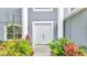 Inviting entryway with double doors and lush landscaping at 943 Van Loon Ct, Kissimmee, FL 34758