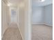 Hallway view with carpet floors, white doors, and access to other rooms at 943 Van Loon Ct, Kissimmee, FL 34758