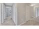 Hallway with carpet and white doors leading to bedroom and bathroom at 943 Van Loon Ct, Kissimmee, FL 34758