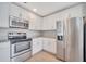 Modern kitchen features stainless steel appliances, granite countertops, and white cabinetry at 943 Van Loon Ct, Kissimmee, FL 34758