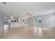 Open-concept living area with tile flooring, seamlessly connecting kitchen and outdoor spaces at 943 Van Loon Ct, Kissimmee, FL 34758