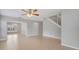 Open-concept floor plan with tiled floors and staircase at 943 Van Loon Ct, Kissimmee, FL 34758