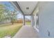 Outdoor covered patio with concrete slab, leading to the backyard at 943 Van Loon Ct, Kissimmee, FL 34758