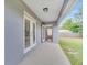 Covered patio with concrete slab, showing view into the home at 943 Van Loon Ct, Kissimmee, FL 34758