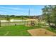 Neighborhood playground features various play sets and a lovely nearby pond at 943 Van Loon Ct, Kissimmee, FL 34758