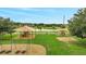 Community playground with lush landscaping and various play structures, great for outdoor fun at 943 Van Loon Ct, Kissimmee, FL 34758