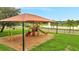 The Community playground with climbing structures and water views for outdoor enjoyment at 943 Van Loon Ct, Kissimmee, FL 34758